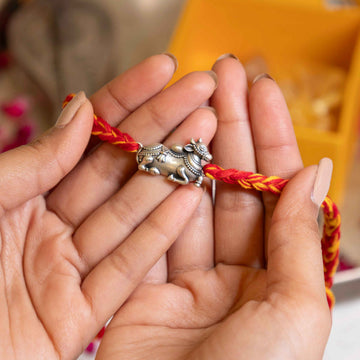 Handcrafted 92.5 Silver Nandi Rakhi on Red and Yellow Thread – Spiritual Raksha Bandhan Design
