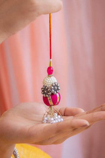 Designer Lumba Rakhi for Bhabhi – Pearl Floral Tassel Rakhi in Pink & Gold