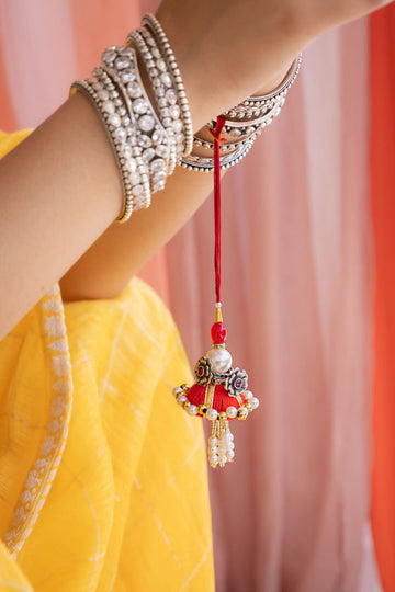 Elegant Latkan Lumba Rakhi for Bhabhi – Pearl & Floral Design in Festive Red