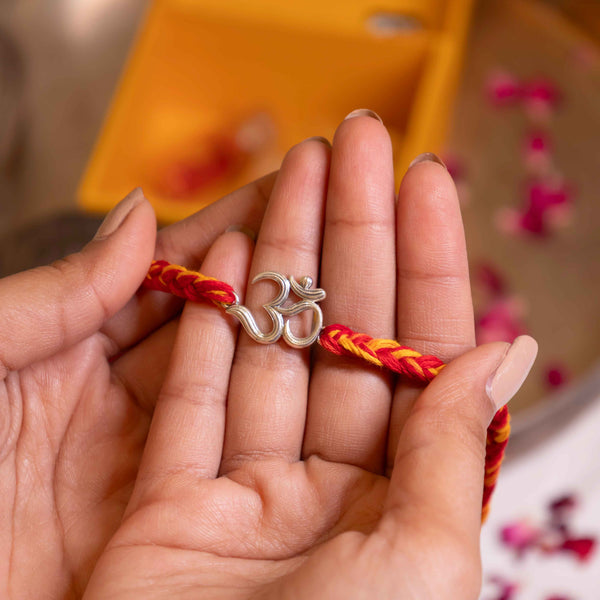 Handcrafted 92.5 Silver Om Rakhi with Red and Yellow Moli Thread