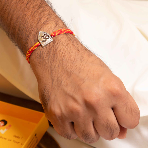 Temple Arch Om Rakhi in 92.5 Silver with Red and Yellow Thread – Spiritual Raksha Bandhan Design