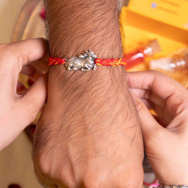 Handcrafted 92.5 Silver Nandi Rakhi on Red and Yellow Thread – Spiritual Raksha Bandhan Design