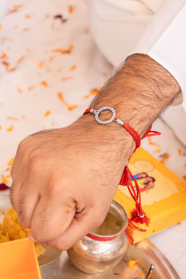 Premium Circular CZ Silver Rakhi with Red & Yellow Moli – Aneytri Raksha Bandhan Collection