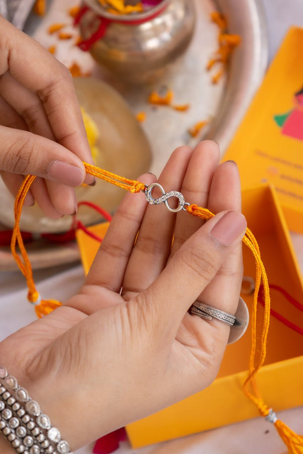 Infinity Symbol Silver Rakhi with CZ Stones & Red-Yellow Moli – Aneytri Raksha Bandhan Collection