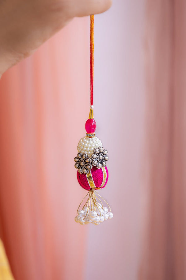 Designer Lumba Rakhi for Bhabhi – Pearl Floral Tassel Rakhi in Pink & Gold