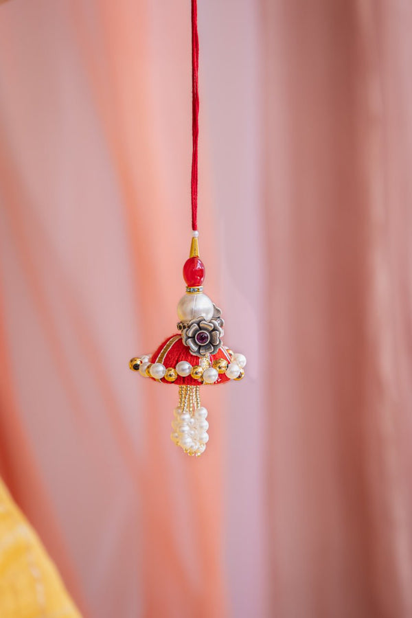 Elegant Latkan Lumba Rakhi for Bhabhi – Pearl & Floral Design in Festive Red