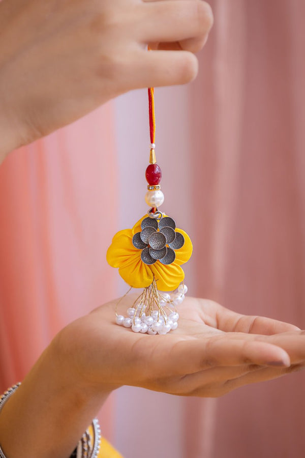 Handcrafted Floral Latkan Rakhi in Yellow with Silver Motif & Pearl Tassels – Aneytri