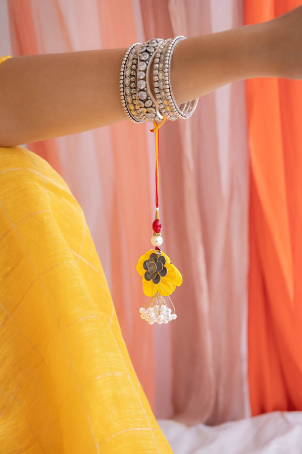 Handcrafted Floral Latkan Rakhi in Yellow with Silver Motif & Pearl Tassels – Aneytri